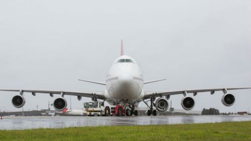 Qantas 747 takes off from Sydney with extra engine on wing