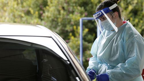 Medical professionals perform COVID testing at a drive through clinic in Ballarat, Victoria.