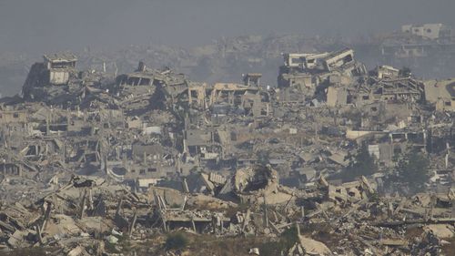 Destroyed buildings in Gaza Strip are seen from southern Israel, Monday, May 26, 2025. (AP Photo/Ariel Schalit)