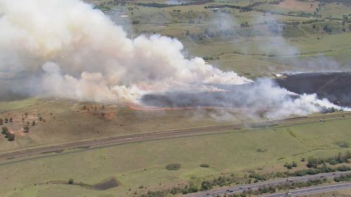 A large grassfire is burning on the edge of Sydney,﻿ with residents warned to stay updated.The fire has burned through bush around Menangle Road, near Menangle in Wollondilly﻿, with waterbombing aircraft called in.
