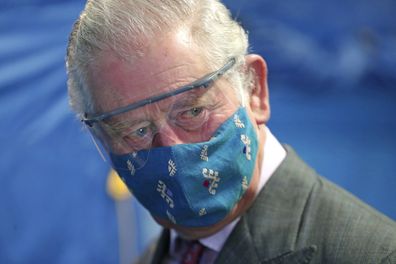 Prince Charles, wearing a face mask to protect against coronavirus, arrives to meet with front line health and care workers administering and receiving the COVID-19 vaccine during a visit to the Gloucestershire Vaccination Centre at Gloucestershire Royal Hospital, in Gloucestershire, England, Dec. 17, 2020.