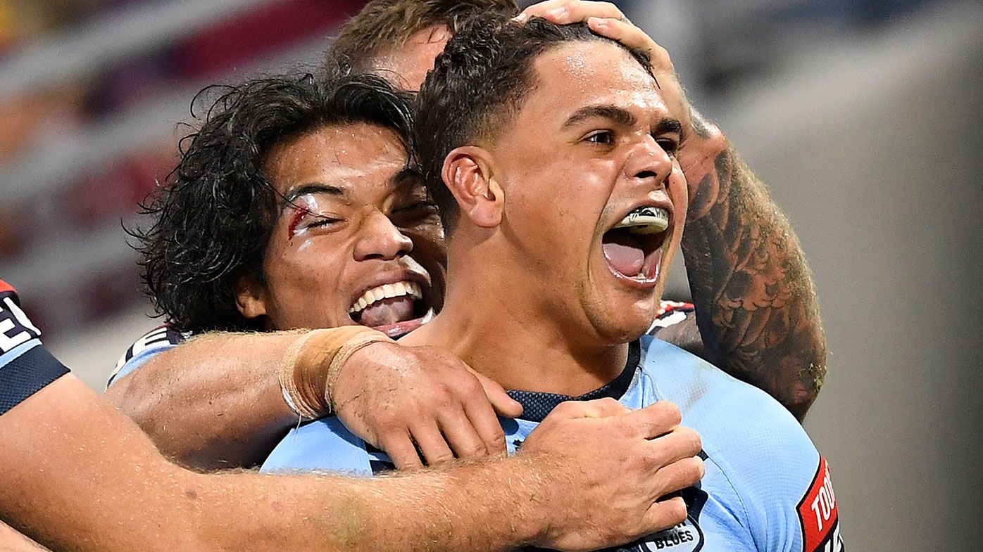  Latrell Mitchell of the Blues celebrates with team mates after scoring a try during game one of the 2021 State of Origin series between the New South Wales Blues and the Queensland Maroons at Queensland Country Bank Stadium on June 09, 2021 in Townsville, Australia. (Photo by Ian Hitchcock/Getty Images)