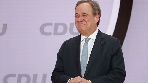 The new elected Christian Democratic Union, CDU, party chairman Armin Laschet stands on the podium after the voting at a digital party convention in Berlin, Germany, Saturday, Jan. 16, 2021