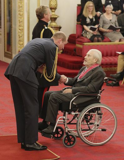Photographer Terry O'Neill is made a CBE by Prince William at Buckingham Palace in 2019.