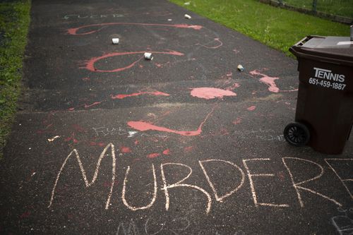 Splattered paint and chalk writing are on the driveway of the home of fired Minneapolis police Officer Derek Chauvin. Chauvin is the white police officer seen on video kneeling against the neck of George Floyd, before he died.