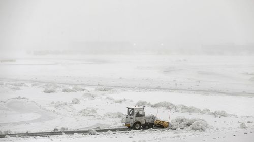 Snow plows work to keep the grounds clear at Newark Liberty International Airport. (AAP)