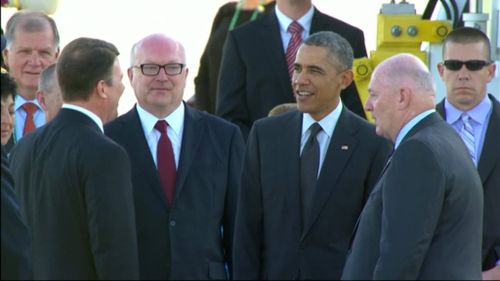 Attorney-General George Brandis and Governor-General Sir Peter Cosgrove greet Mr Obama. (9NEWS)