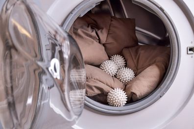 the laundry balls and the down jacket are in the washing machine