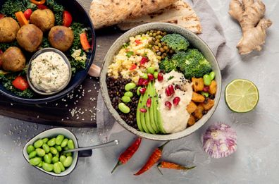 Vegan dishes assortment on light background. Mediterranean diet concept. Flat lay, top view