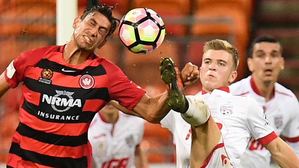 Wanderers midfielder Bruno Pinatares and Adelaide United's Riley McGree. (AAP)