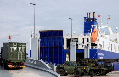 German military vehicles are loaded onto a ship in Emden, Germany, bound for the Trident Juncture exercises in Norway.