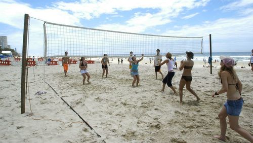 Recovery beach volleyball is popular on Surfers Paradise beach. (Image: AAP)