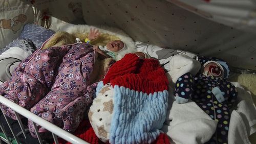 Premature babies who were left behind by their parents lie in a bed in hospital number 3 in Mariupol, Ukraine