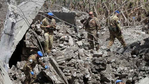 Italian UN peacekeeper soldiers inspect a small bridge that was destroyed by an Israeli airstrike, in Maaliya village, south Lebanon