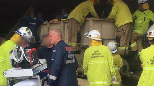 Emergency services working to free Gavin Boekel following an accident at a Queensland farm.