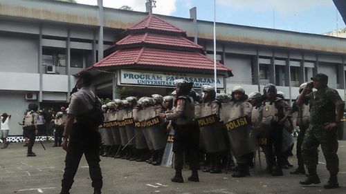 Indonesian police officers stand guard