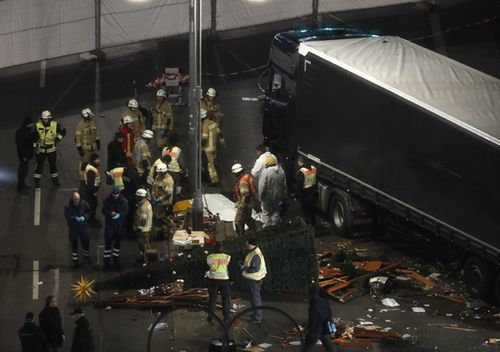 Authorites inspect the scene after a truck sped into a Christmas market in Berlin, killing at least 12 people and injuring dozens more.