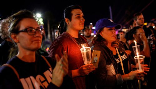 Thousands of people mark two weeks since the mass shooting at a Las Vegas country music festival by walking the Strip in Las Vegas. (AP)