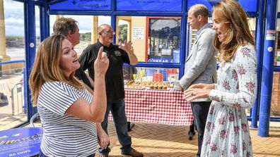 Britain's Prince William and Kate, the Duchess of Cambridge meet with business owners in Barry Island, Wales, Wednesday Aug. 5, 2020, during their visit to speak to local business owners about the impact of COVID-19