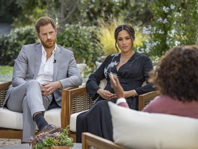 This image provided by Harpo Productions shows Prince Harry, from left, and Meghan, The Duchess of Sussex, in conversation with Oprah Winfrey. (Joe Pugliese/Harpo Productions via AP)