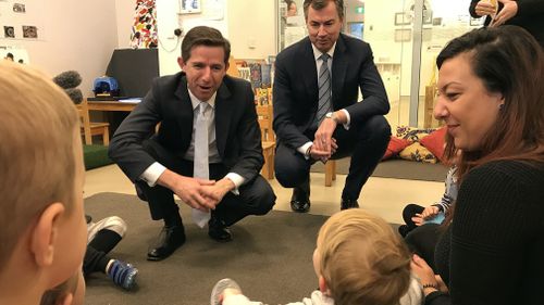 Minister for Education and Training Simon Birmingham (centre) and Minister for Human Services Michael Keenan (right) are seen during a visit the Acacia Children's Centre in Canberra today. Picture: AAP