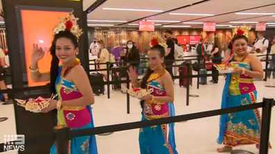 Bronte Gossling waiting in queue at the check-in desk to fly to Bali