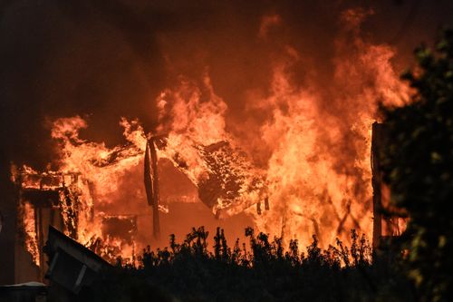Pacific Palisades, CA - January 08: A home burns along Sunset Boulevard during the Palisades Fire on Wednesday, January 8, 2025, in Pacific Palisades, CA.  (Photo by Jeff Gritchen/MediaNews Group/Orange County Register via Getty Images)