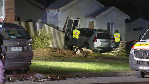 Car crashes into side of Guildford home where woman was sleeping.