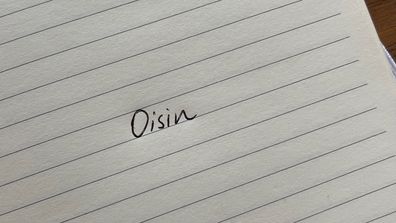 Oisin Irish name written on notepad. 