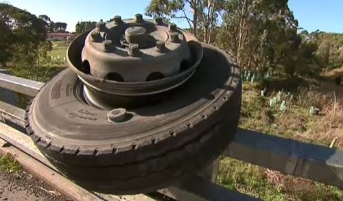 The wheel of the truck sits on the guardrail of the bridge. Picture: 9NEWS