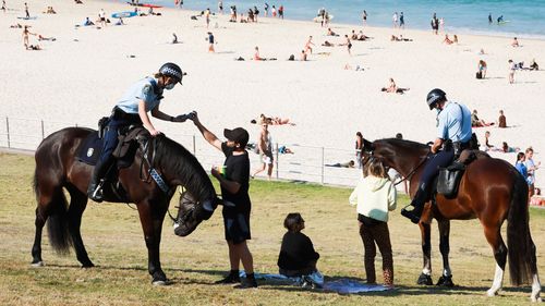 Police check the addresses of people at Bondi Beach during the COVID-19 lockdown.