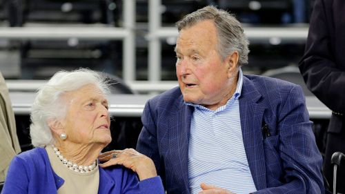 President George H.W. Bush and his wife Barbara Bush speak before a college basketball regional final game in 2015. (AP)