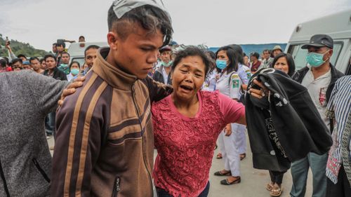 A mother cries as she reunites with her son, who survived from a boat's sinking in Lake Toba, in North Sumarta. Picture: EPA