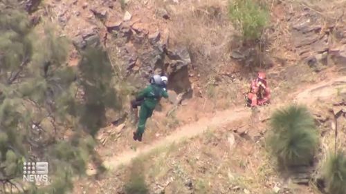 An emergency helicopter rescued a 61-year-old woman who fell 10 meters while walking her dog along a trail in the Waterfall Gully in Adelaide this morning.