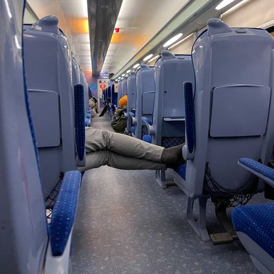 Unrecognizable man sleeps in the train