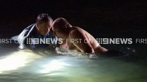The officers repeatedly dived into the water only to find no one was inside the car. (9NEWS)