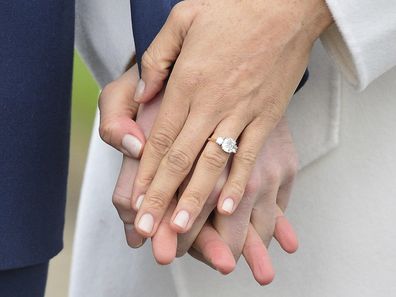 Meghan Markle wears her engagement ring as she poses with Britain's Prince Harry for the media in the grounds of Kensington Palace in London, Monday Nov. 27, 2017. 