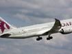 A Qatar Airways plane flying through the sky