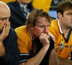 Dejected Wallabies Nathan Sharpe, Bill Young and David Lyons watch England celebrate in 2003.