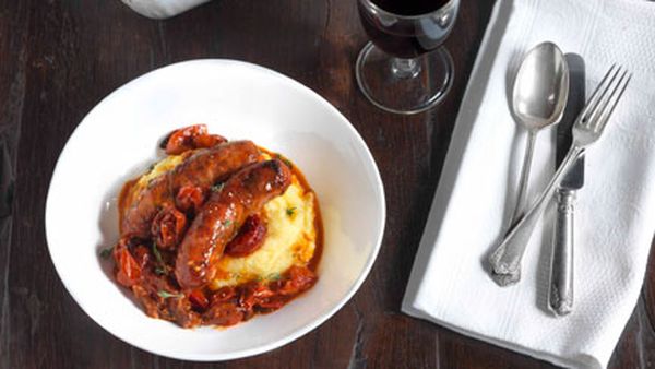 Sausages with roasted onion, tomato and polenta