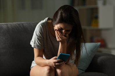 Sad teen receiving bad news online at home. 