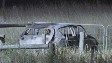 Three bodies were found in a burnt-out hatchback beside a Melbourne highway.