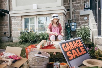 Garage sale in yard with sign