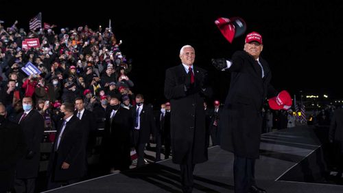 President Donald Trump and Vice President Mike Pence arrive for a campaign rally at Gerald R. Ford International Airport in Grand Rapids, Michigan.