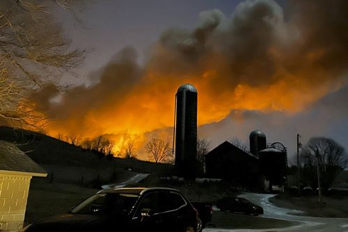 In this photo provided by Melissa Smith, a train fire is seen from her farm in East Palestine, Ohio, Friday, Feb. 3, 2023. 