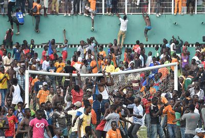 Jubilant supporters tear down the crossbar at one goal.