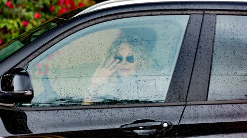 Actress Meg Ryan waves to paparazzi from her car. (AFP)