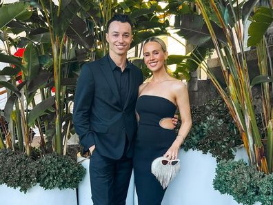 Dj Tigerlily poses with a growing bump at an event with husband Scott Lawson.