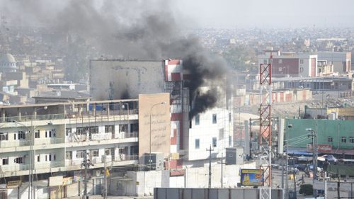 Smoke rises from a building where ISIS fighters had sheltered in Kirkuk. (AFP)