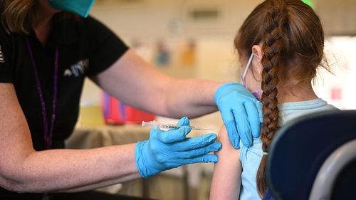 A nurse administers a pediatric dose of the Covid-19 vaccine to a girl at a L.A. Care Health Plan vaccination clinic at Los Angeles Mission College in the Sylmar neighborhood in Los Angeles, California, January 19, 2022 